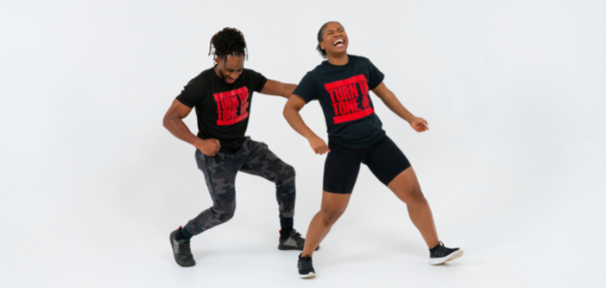 Two Afrobics instructors dance
