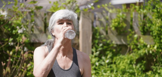 Lady drinking water after workout